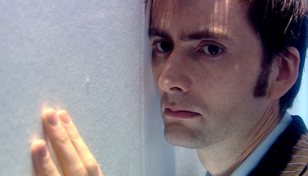 The Doctor crying against a wall